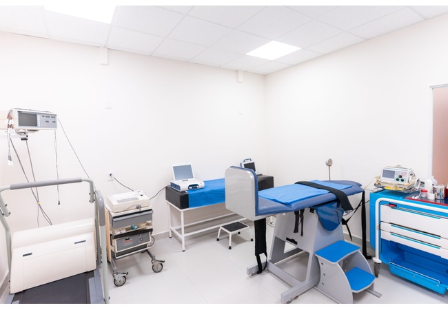 Clinical examination room with examination furniture and medical equipment