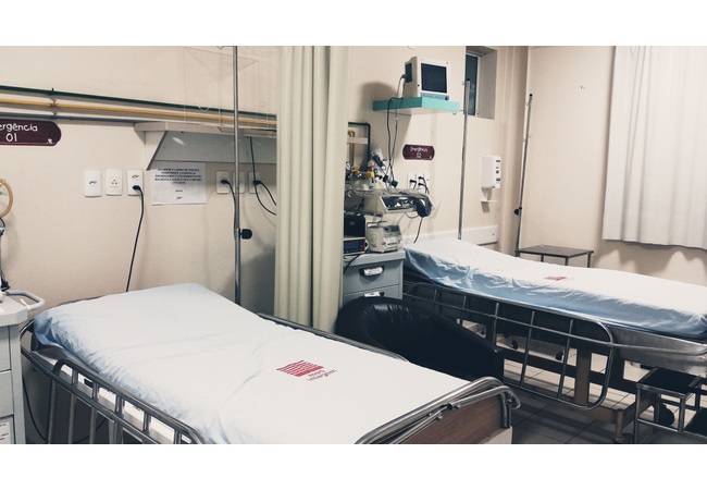 wo-bed hospital room with curtains and bedside medical equipment